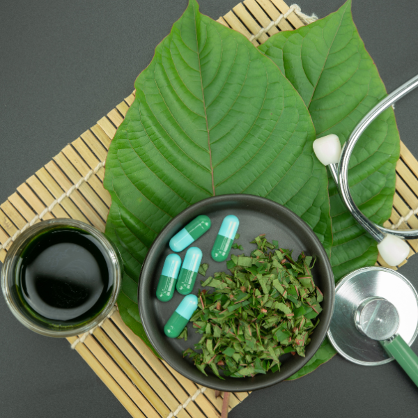 Kratom leaves tea capsules and stethoscope
