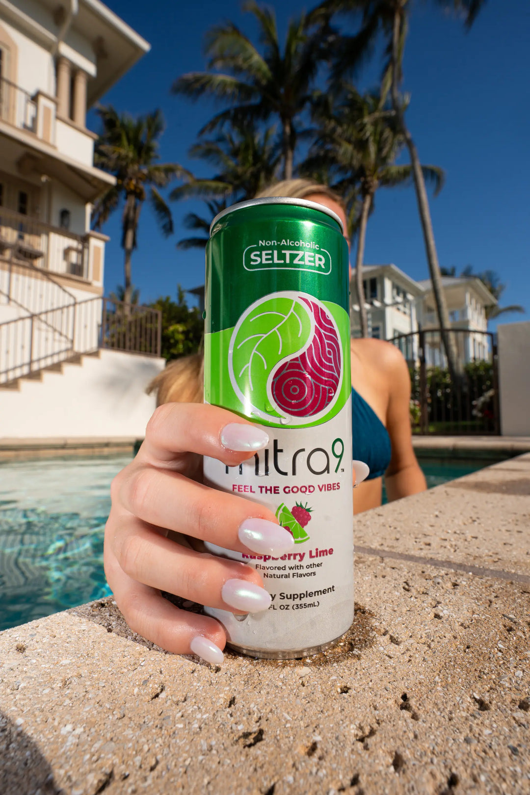 Woman Sipping Mitra9 Kratom Drink Poolside
