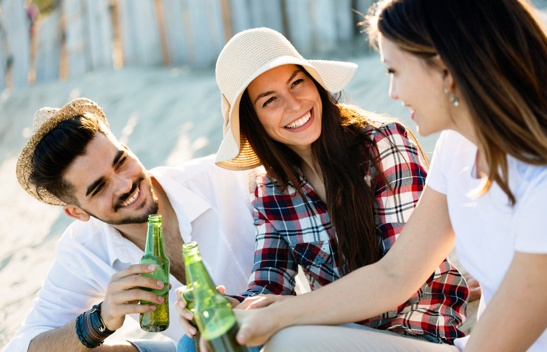 Man and two women laughing drinking non alcoholic beer