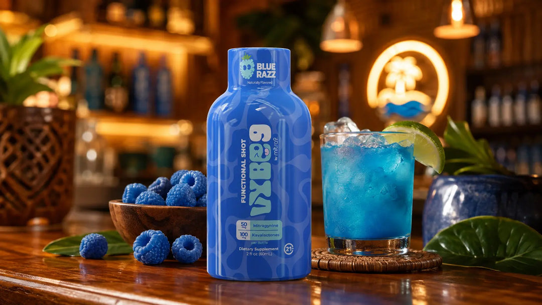 Blue Razz Vybe9 functional shot displayed in a tropical kava bar setting with a blue mixed drink, lime garnish, and berry accents.