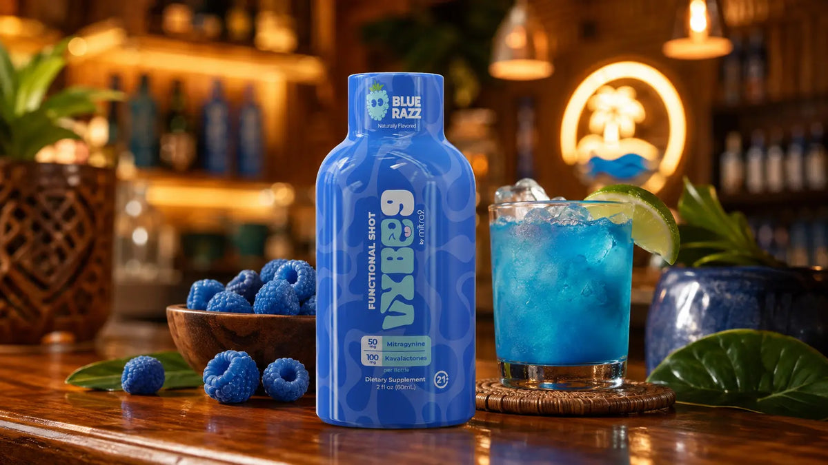 Blue Razz Vybe9 functional shot displayed in a tropical kava bar setting with a blue mixed drink, lime garnish, and berry accents.