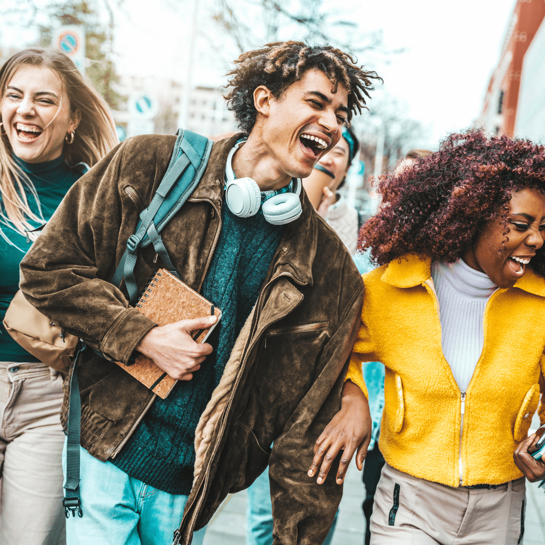 College students laughing and walking on campus