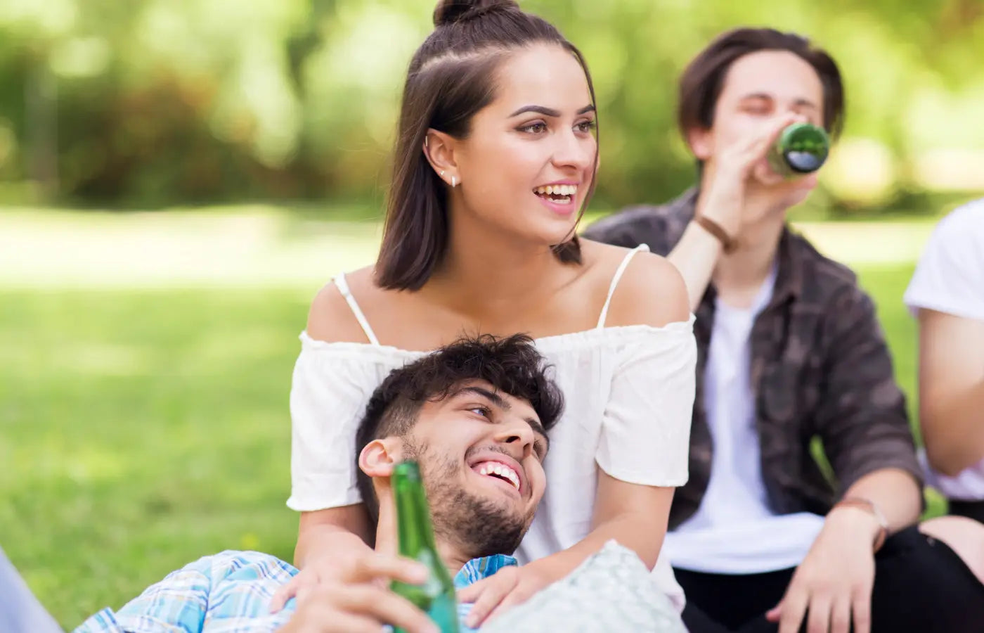 Friends Drinking Non Alcoholic Beer Outdoors at Park
