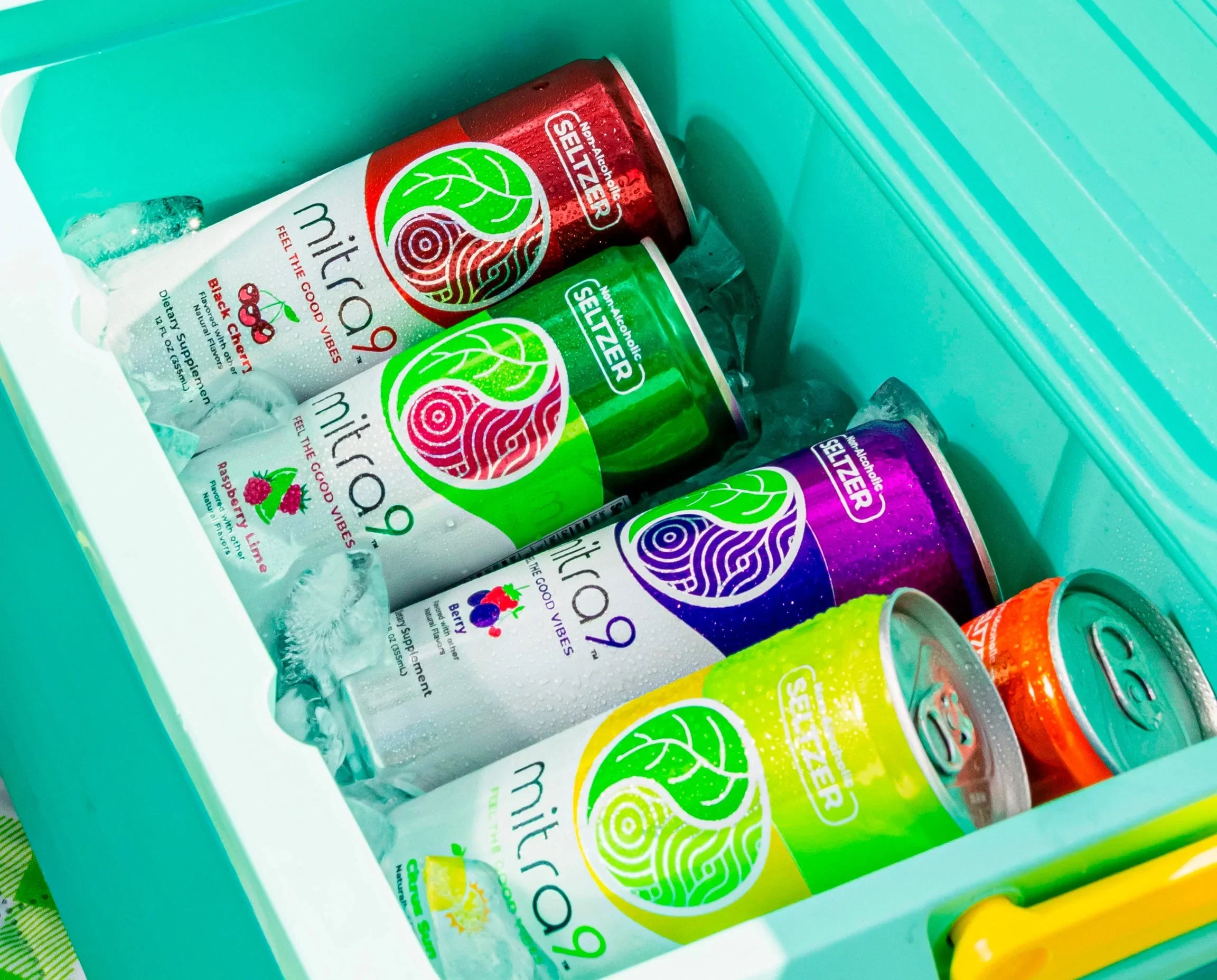Mitra9 functional seltzer variety pack in cooler with ice featuring kratom seltzer flavors raspberry lime, black cherry, citrus, and berry – refreshing non-alcoholic functional beverages ready to drink