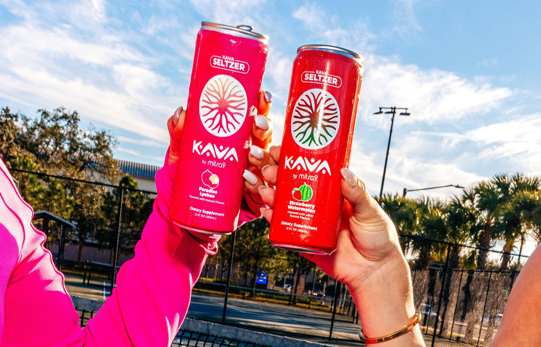 People clinking cans of Kava Seltzer by Mitra9 outdoors, illustrating the social, alcohol-free effects of drinking kava for relaxation and connection