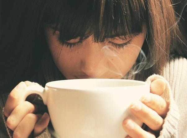 Woman drinking Kava tea for better health and wellness