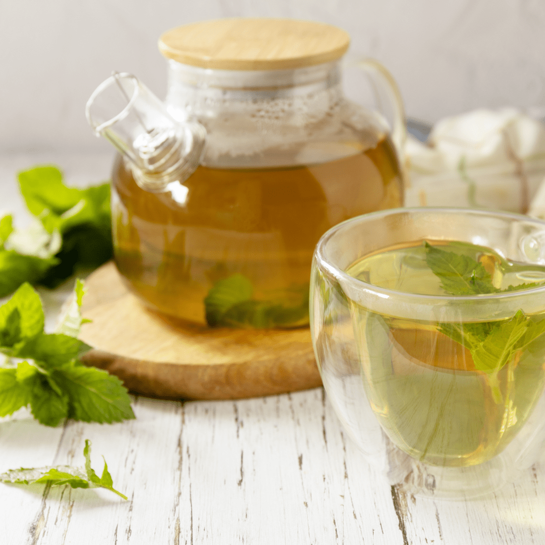 Kratom Tea Pot and Glass with Green Leaves