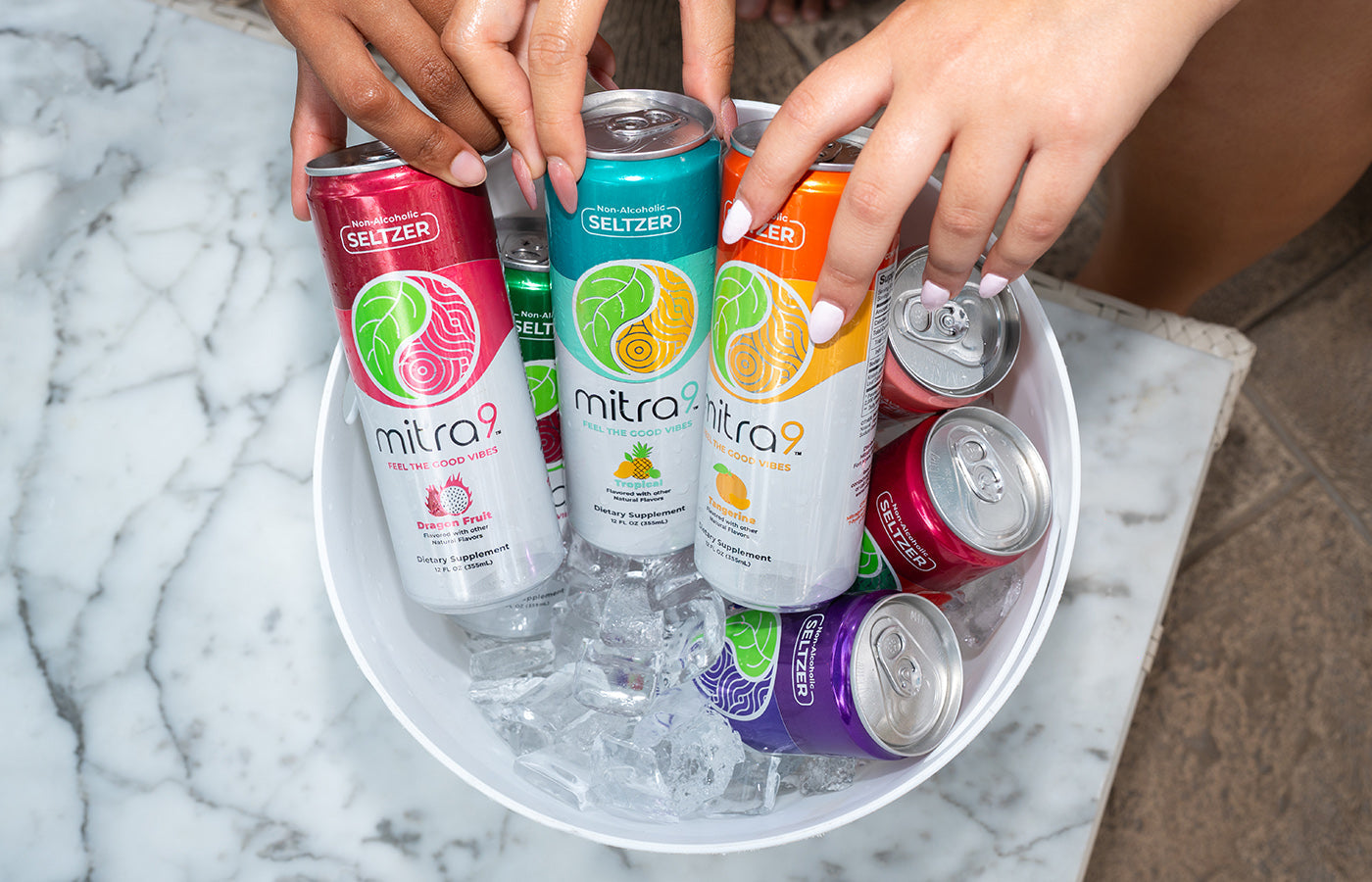Woman Grabbing Mitra9 Non Alcoholic Drinks from Ice Bucket