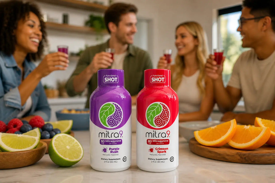 Mitra9 Purple Rush and Crimson Spark mitragynine shots on kitchen counter with fresh fruit, friends toasting in background, social lifestyle setting, alcohol free functional drink alternative