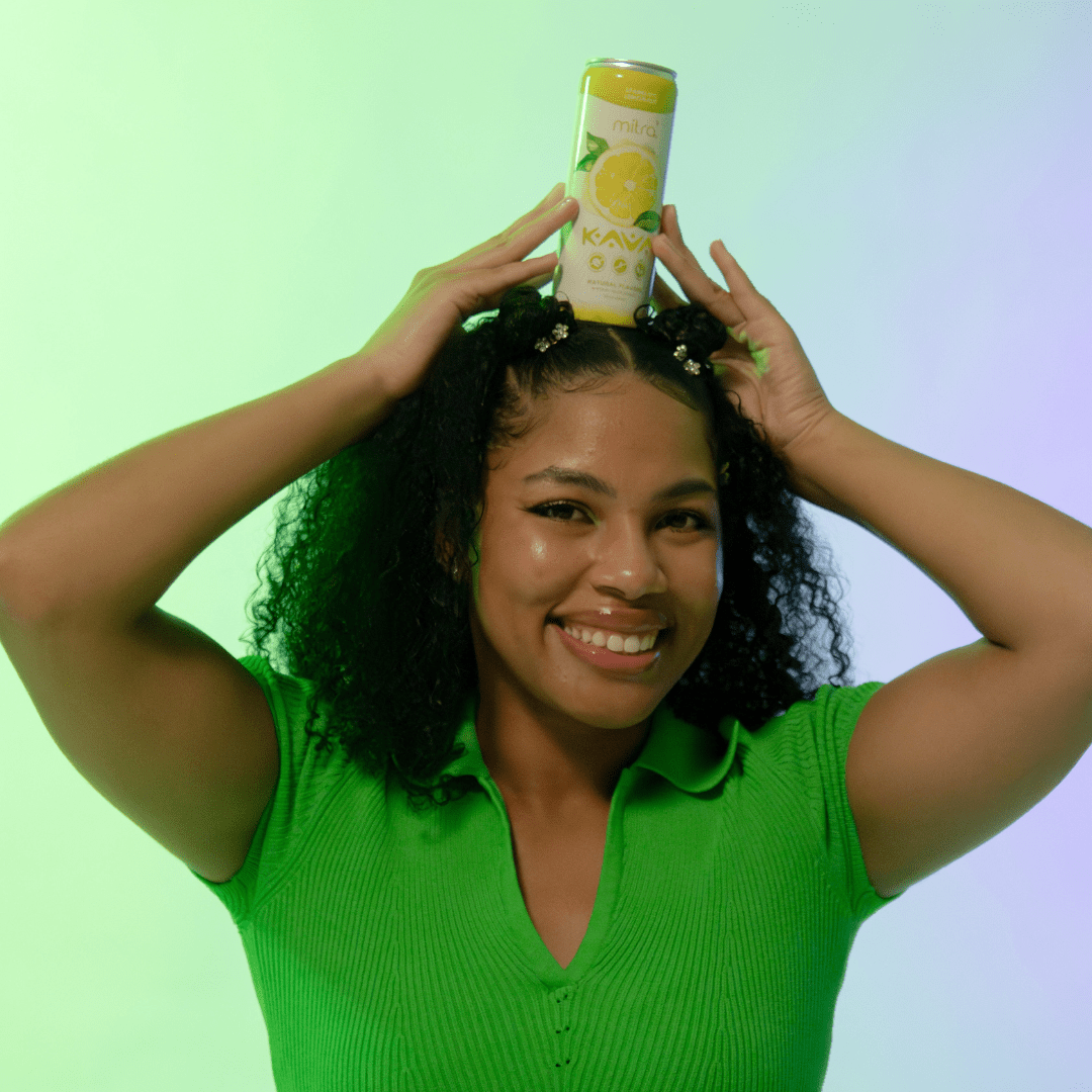 College Student holding Mitra9 Kava can on her head