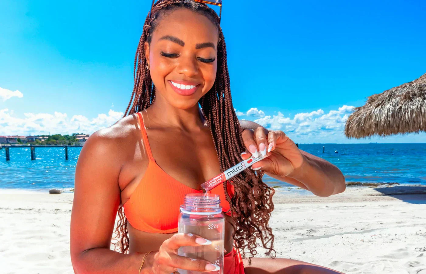 Woman at Beach Mixing a Mocktail