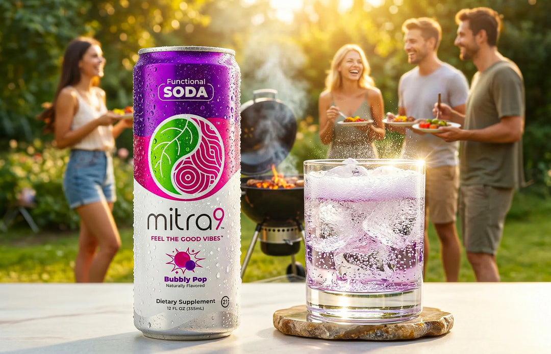 Mitra9 Bubbly Pop functional soda can next to a glass of sparkling pink drink with ice, set at a backyard gathering with friends enjoying an alcohol alternative beverage outdoors in warm sunlight