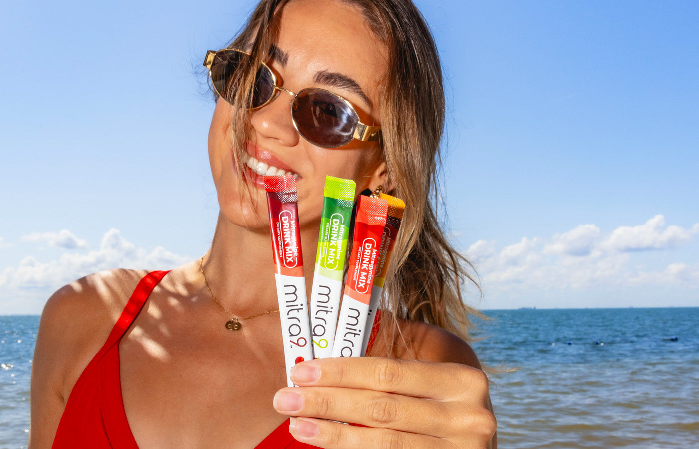 Woman at Beach Holding Kratom Drink Mixes