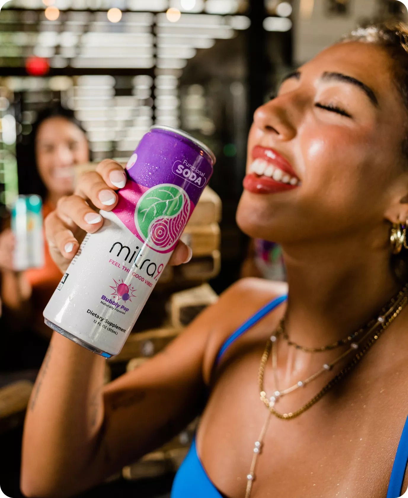 Woman holding a can of bubbly pop functional soda in a casual setting